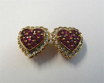 Lot 712 - A Pair of Ruby and Diamond Heart Shape Earrings, pavé set rubies within a border of diamonds, in