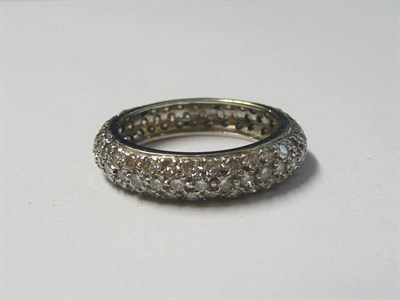 Lot 713 - A Diamond Bombé Eternity Ring, three rows of round brilliant cut diamonds in white claw...