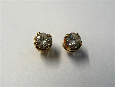 Lot 717 - A Pair of Diamond Solitaire Stud Earrings, round brilliant cut diamonds held in yellow four...