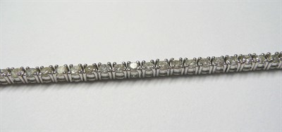 Lot 718 - A Diamond Line Bracelet, the round brilliant cut diamonds held in white claw settings, total...