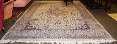 Lot 1083 - Indian carpet, the ivory field of floral vines centred by a medallion framed by spandrels and...