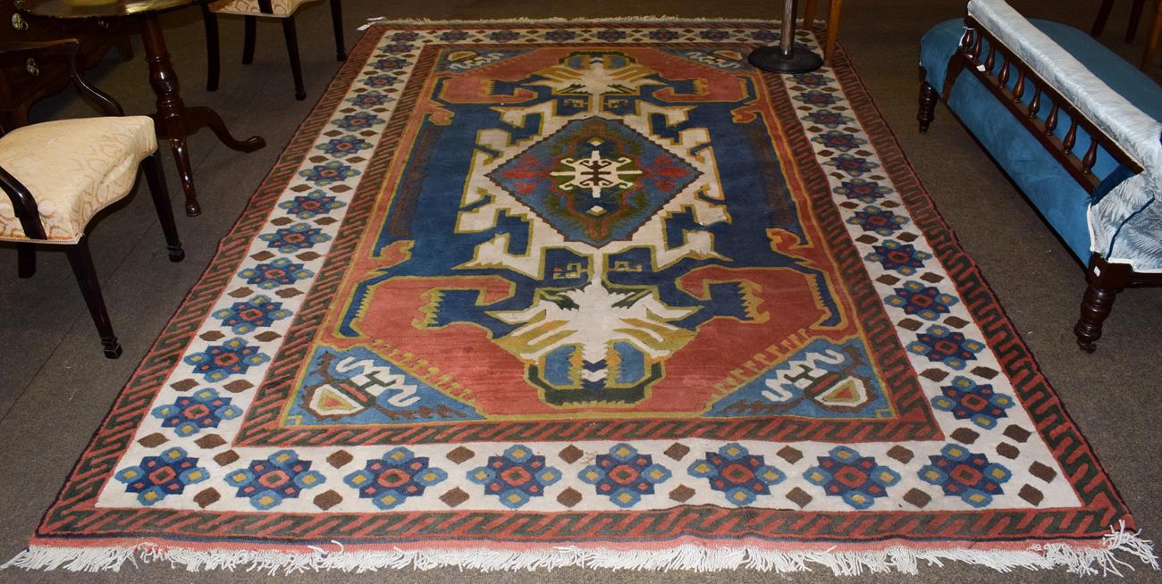 Lot 1084 - Kozak Anatolian carpet, indigo field with an ivory medallion enclosed by ivory borders...