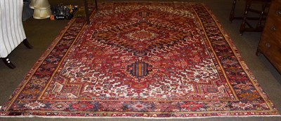 Lot 1085 - Heriz carpet, the tomato red field of angular vines around a stepped medallion enclosed by...
