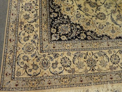Lot 1089 - Nain part silk carpet the ivory field of scrolling vines and palmettes around a flower head...