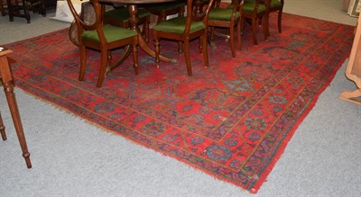 Lot 1090 - Ushak carpet, the tomato red field with columns of geometric medallions, enclosed by borders of...