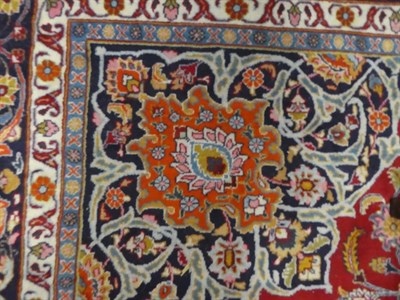 Lot 1093 - Mashad carpet, the light red field of vines around a medallion, framed by spandrels and indigo...