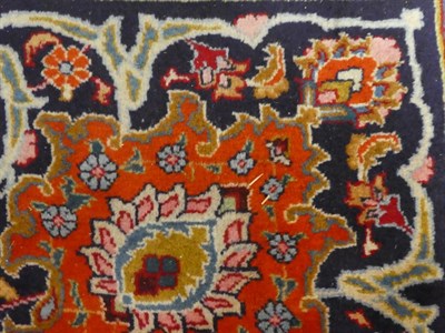 Lot 1093 - Mashad carpet, the light red field of vines around a medallion, framed by spandrels and indigo...