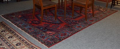 Lot 1094 - Viss carpet, the scarlet field with three hooked medallions enclosed by spandrels and sky blue...