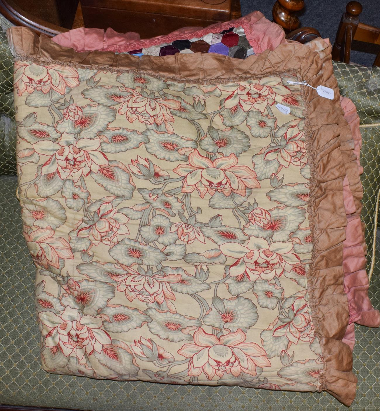 Lot 1121 - A late 19th century patchwork bed cover with cotton trim and floral reverse