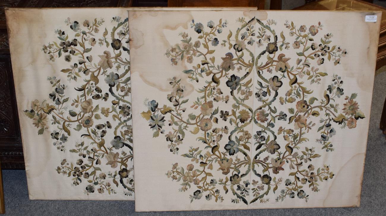 Lot 1125 - A pair of embroidered silk work panels depicting scrolling floral sprigs on a cream silk...