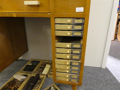 Lot 1162 - An early 20th century oak opticians desk together with collection of spectacles, lenses, two albums
