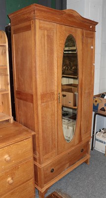 Lot 1178 - An early 20th century oak mirror door wardrobe; a walnut cabinet with sliding glass doors; an early