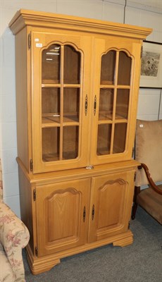 Lot 1182 - A reproduction oak display cabinet with two glazed doors and two cupboard doors