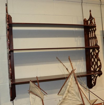 Lot 1187 - A mahogany fret-carved hanging set of three shelves, 91cm high by 93cm wide