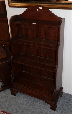 Lot 1202 - A reproduction oak waterfall bookcase, the base with a single drawer, 63cm wide by 30cm deep by...