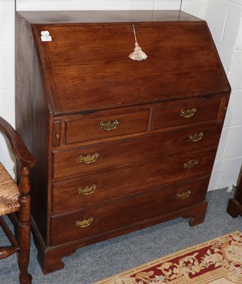 Lot 1205 - A reproduction oak five-drawer bureau