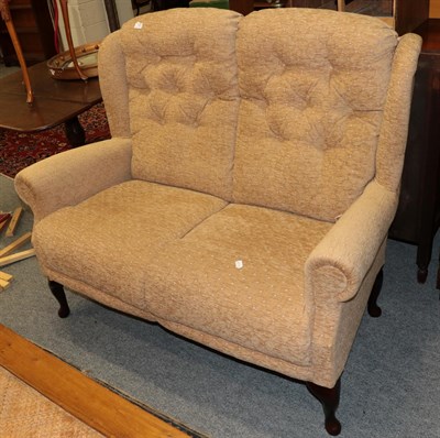 Lot 1220 - A modern style two-seater sofa in buttoned fabric