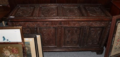 Lot 1227 - A late 17th century oak panelled coffer, hinged lid, bearing date, carved detail and bracket feet