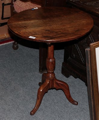 Lot 1228 - An 18th century oak tilt-top table
