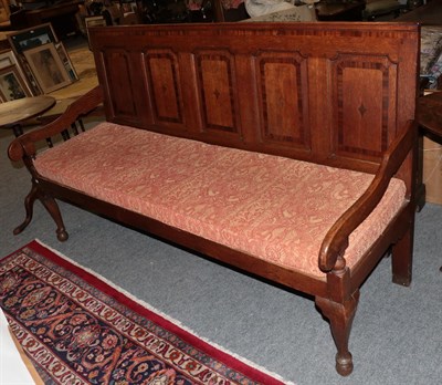 Lot 1229 - A late George III oak and mahogany and crossbanded settle with later seat and squab cushion