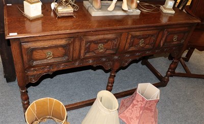 Lot 1245 - A reproduction oak dresser base with four geometric moulded drawers