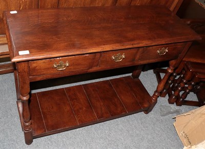 Lot 1250 - A Titchmarsh & Goodwin style oak three-drawer hall table with spindle legs, 99cm wide by 36cm...