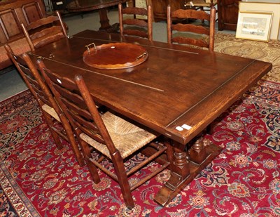 Lot 1253 - A Titchmarsh & Goodwin style oak refectory dining table with seven rush seated chairs,...