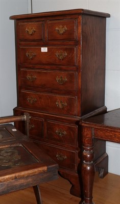 Lot 1291 - A reproduction oak chest on chest of small proportions, 47cm wide by 31cm deep by 92cm high