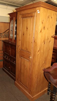 Lot 1295 - A single pine wardrobe, pine linen chest, a Victorian pine, glazed wall mounted cupboard and a late