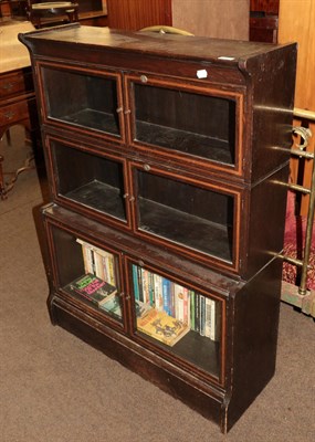 Lot 1297 - An early 20th century oak bookcase with glazed doors
