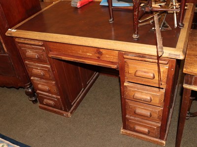 Lot 1306 - An early 20th century pine desk with leather top, 117cm wide, 71cm wide by 81cm high