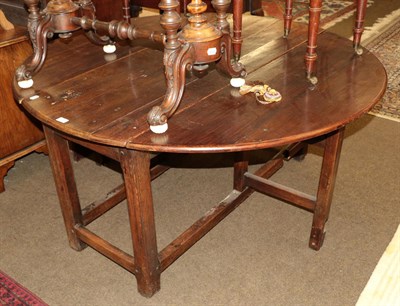 Lot 1311 - An 18th century and later oak drop leaf table, 137cm diameter