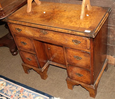 Lot 1313 - A 1920's figured walnut and cross banded kneehole dressing table, 85cm wide by 42cm deep by...