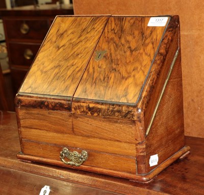 Lot 1317 - A Victorian walnut and figured walnut table top stationary cabinet, the sloping doors opening...