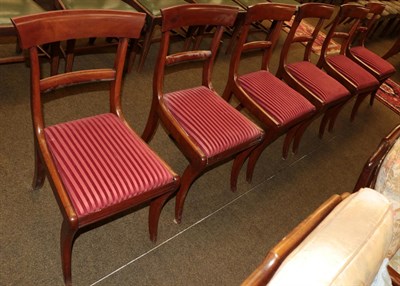 Lot 1341 - A set of six late Regency mahogany dining chairs, with curved back support and striped drop in...