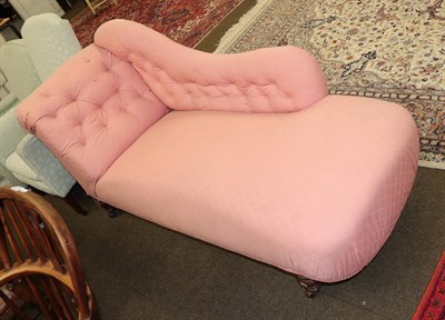 Lot 1346 - A late Victorian chaise lounge upholstered in pink fabric raised on turned legs