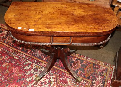 Lot 1350 - A late George III mahogany fold over table