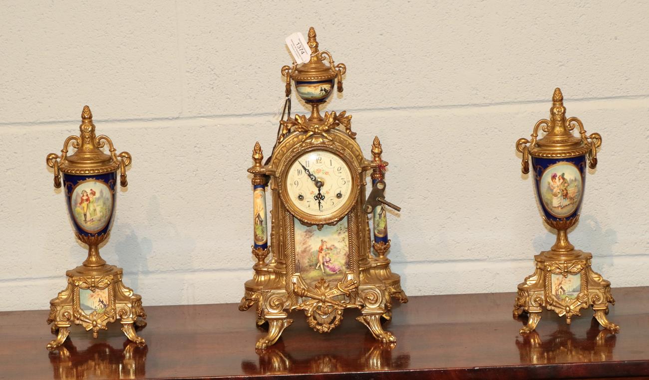 Lot 1374 - A German gilt metal and porcelain clock garniture, 20th century