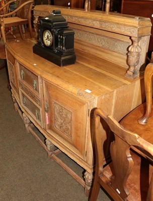 Lot 1375 - An early 20th century carved oak buffet back sideboard with pineapple carved legs