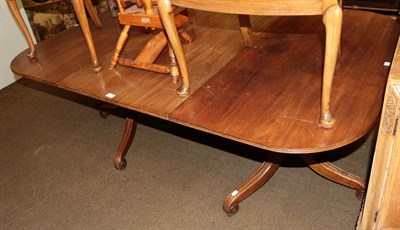 Lot 1376 - A 19th century mahogany D-end dining table with a single leaf raised on twin tripod bases,...