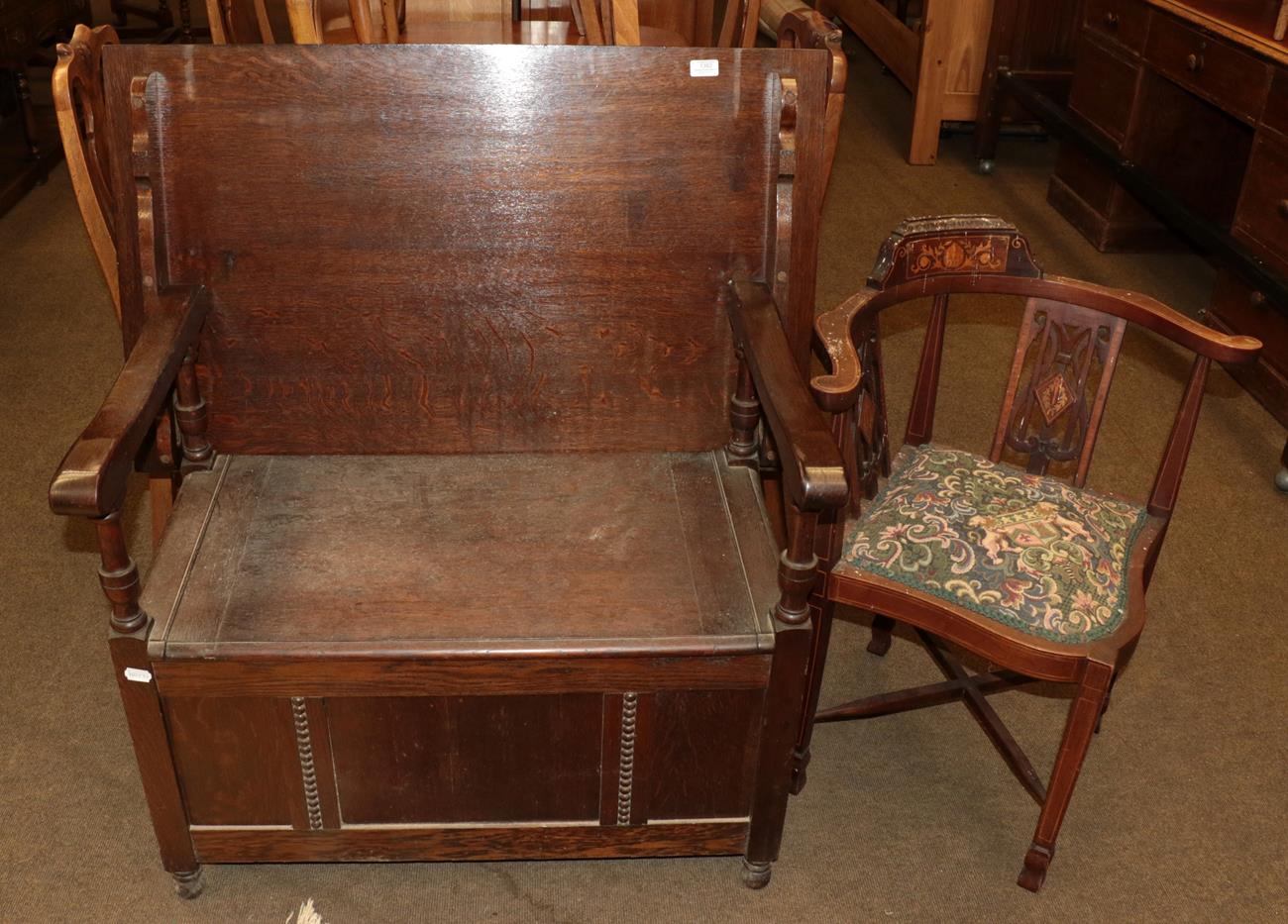 Lot 1382 - An early 20th century carved oak monks' bench, and an upholstered corner chair