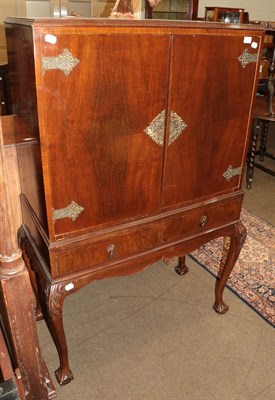 Lot 1383 - A mid 20th century mahogany cocktail cabinet on claw and ball feet