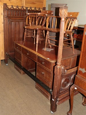 Lot 1385 - A Gothic Revival oak bedstead with linen fold carved headboard and Gothic tracery carvings,...