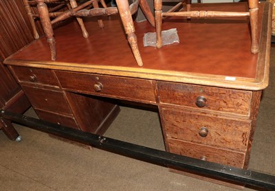 Lot 1386 - An early 20th century oak leather top desk, one side fitted with drawers, the opposing side...