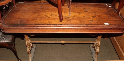 Lot 1390 - A Victorian cast iron pub table, pine top on two supports