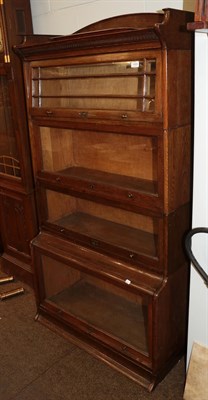 Lot 1404 - An early 20th century oak four-tier sectional bookcase, 88cm wide by 44cm deep by 174cm high