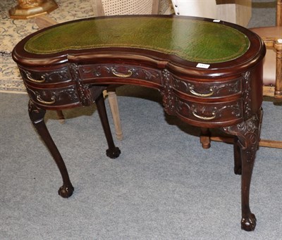 Lot 1417 - A leather inset mahogany reniform writing table