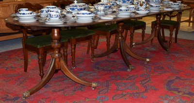 Lot 1230 - Regency style mahogany triple pillar dining table with two additional leaves
