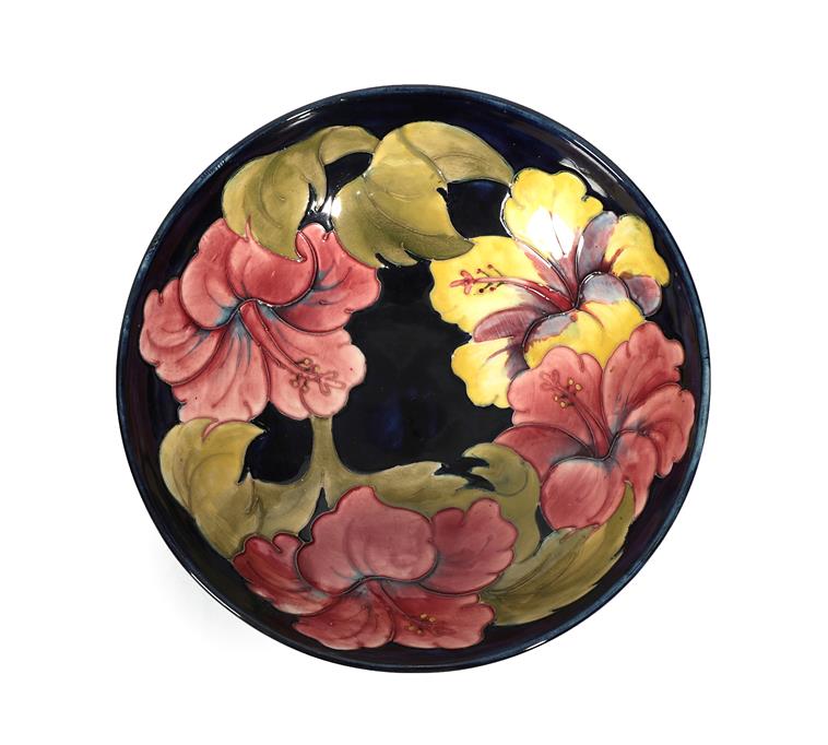 Lot 2 - Walter Moorcroft (1917-2002): An Orchid and Spring Flowers Bowl, on a blue ground, impressed...