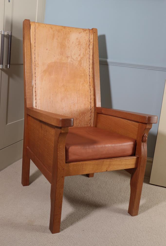 Lot 68 - Workshop of Robert Mouseman Thompson (Kilburn): An English Oak Smoking Chair, slung leather...